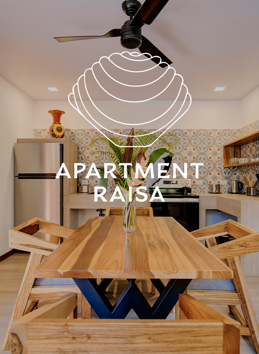 Wooden table in the middle of the kitchen in the Raisa apartment